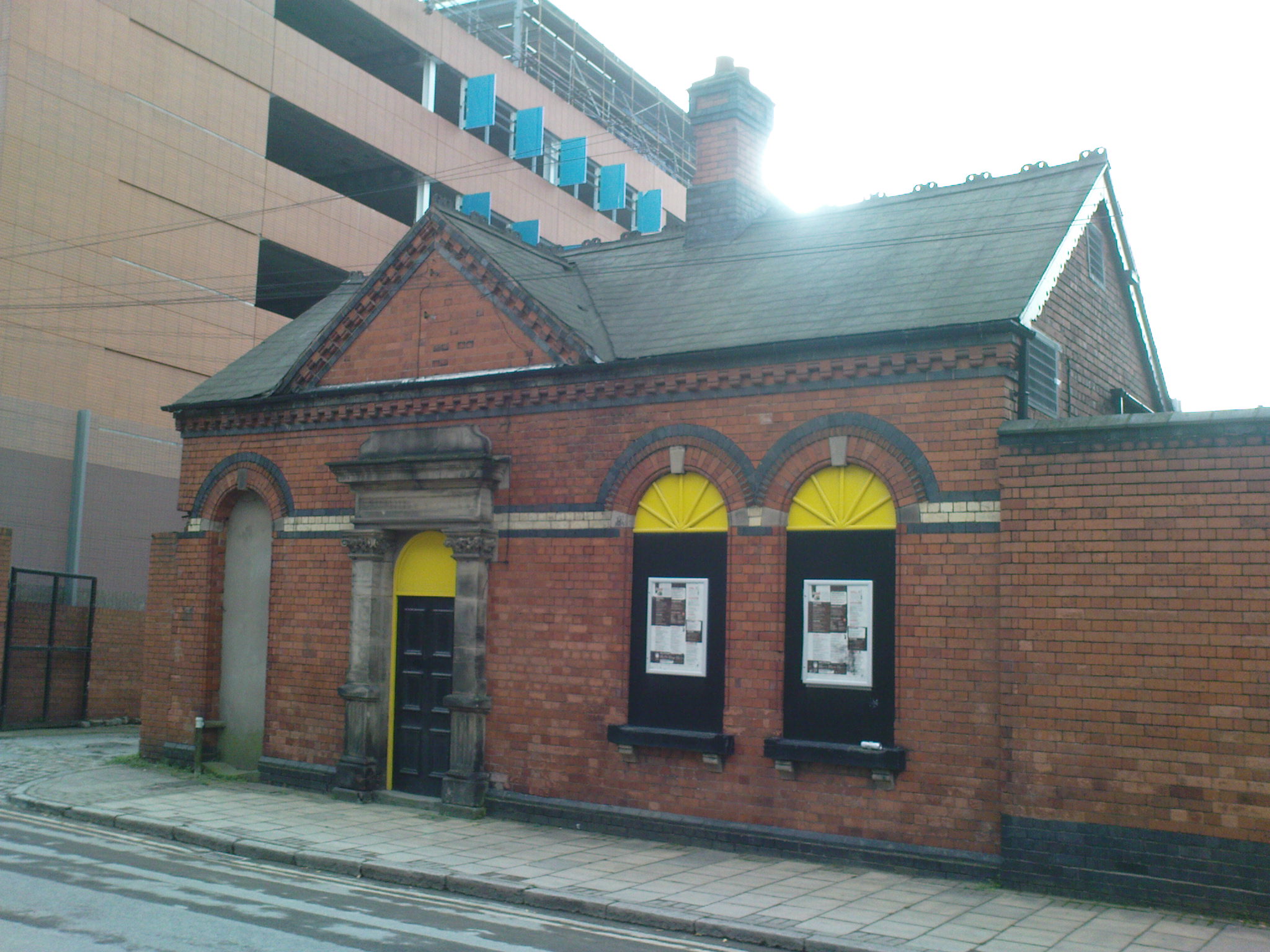 a large brick building with two yellow doors
