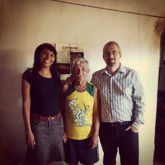 two men, a woman and an old man pose for a po