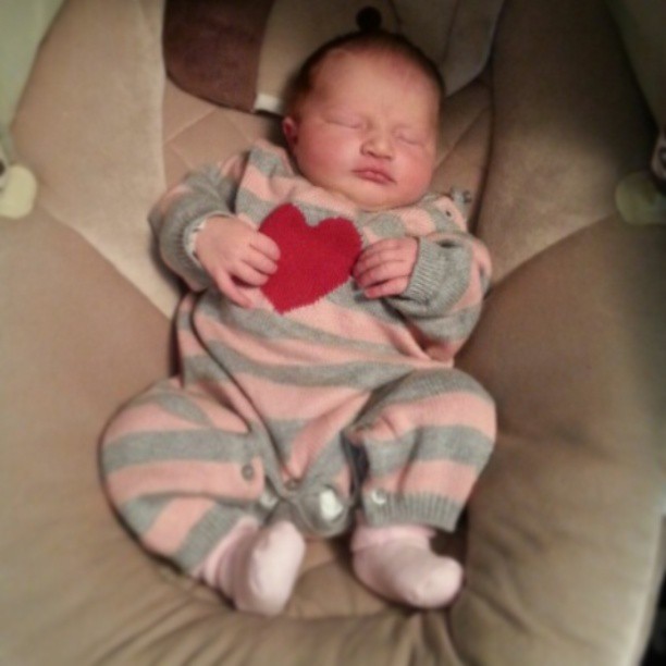 a sleeping baby with a heart on his chest