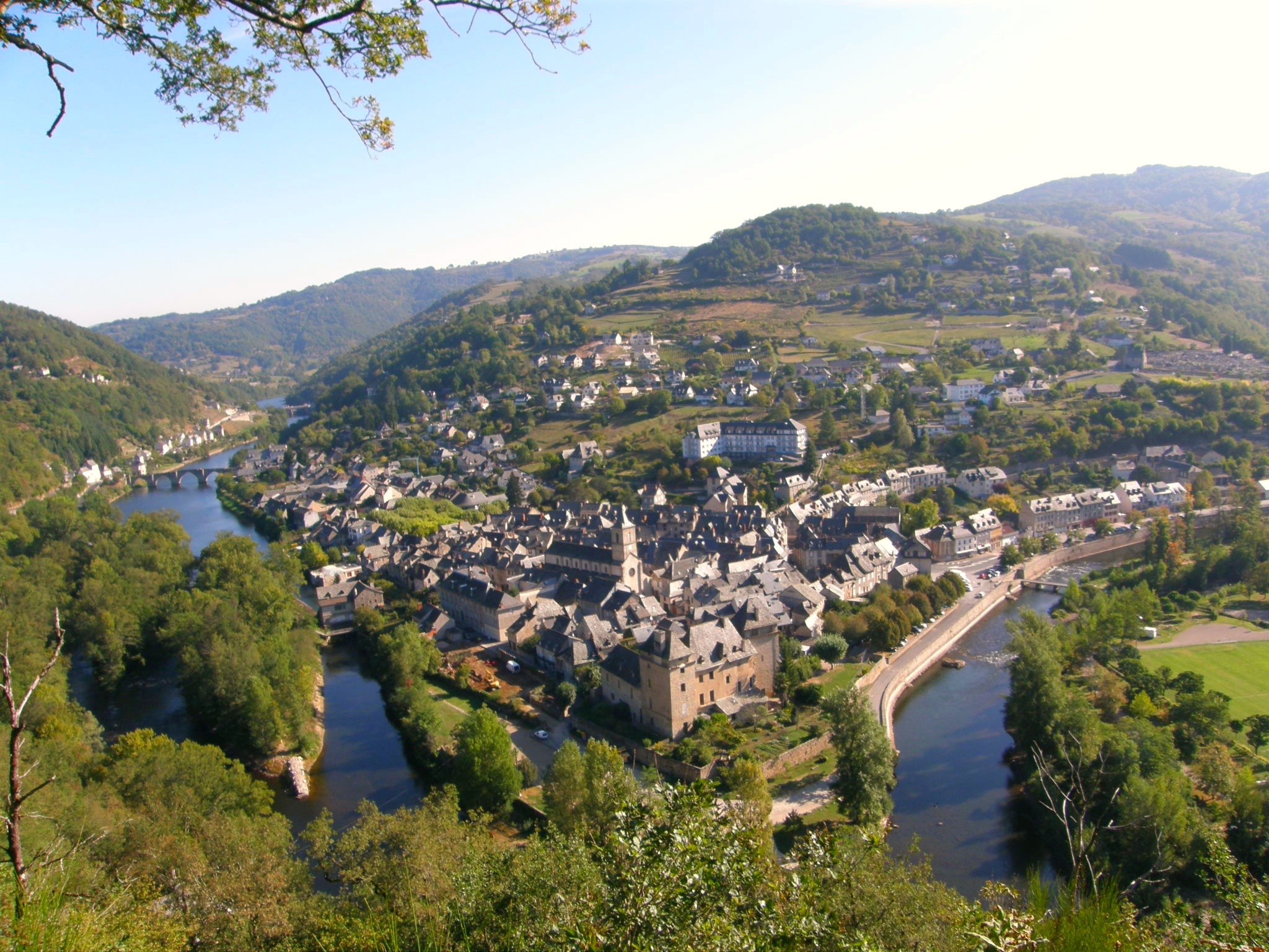 an aerial view of a river valley town and village