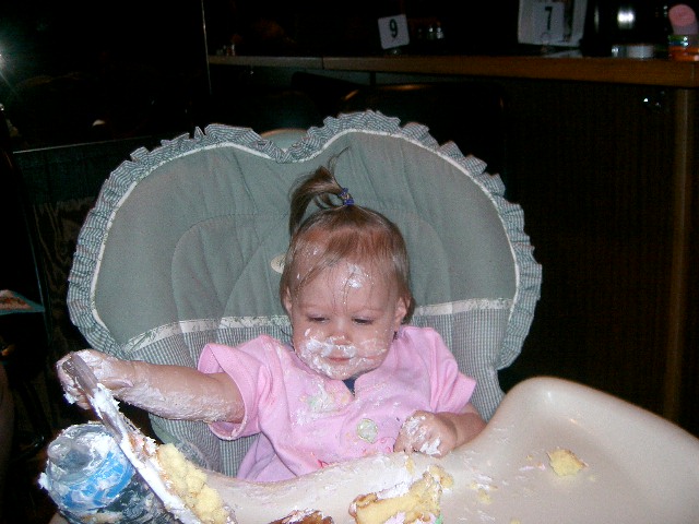 a little girl that is eating some cake