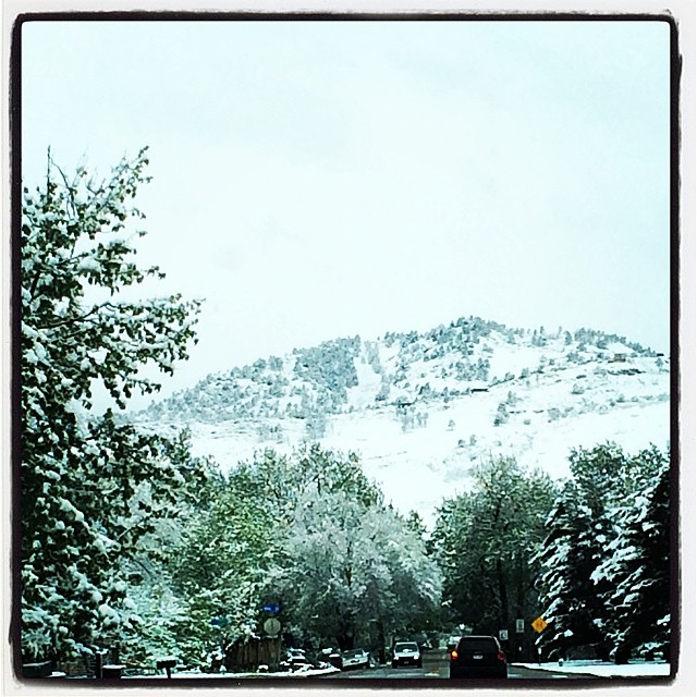 the view of a snow covered mountain from a car window