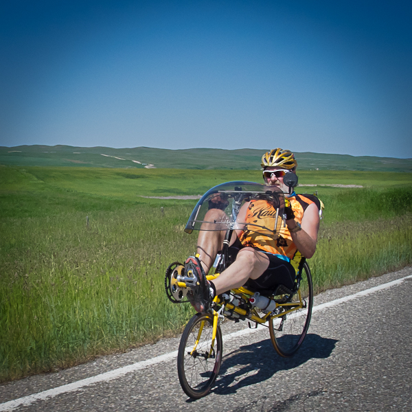 a man rides a bicycle down a road