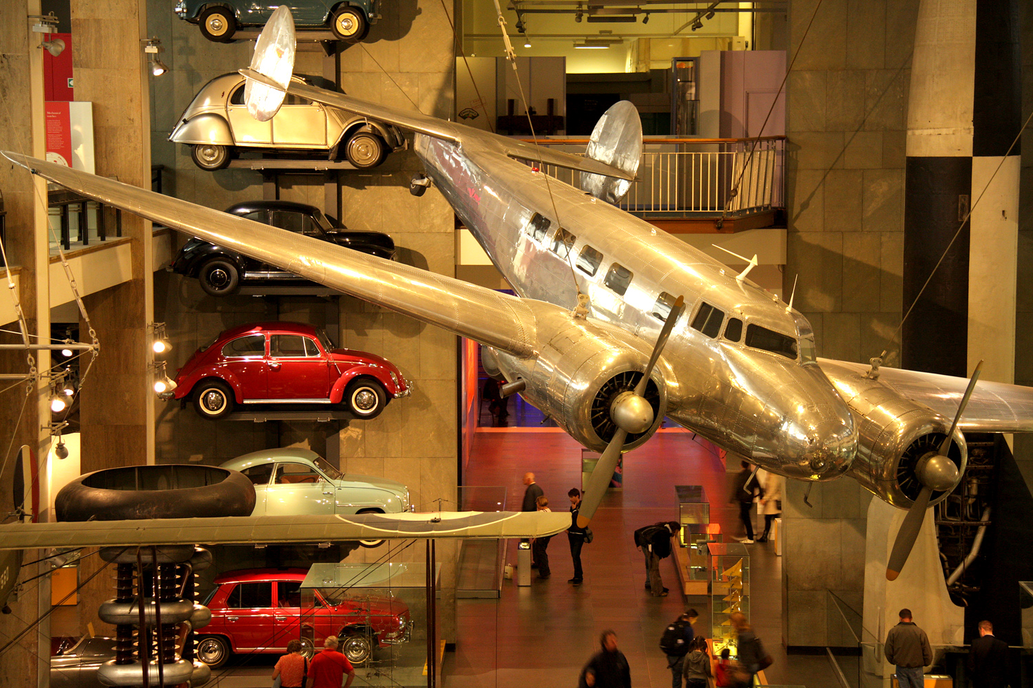 a museum filled with lots of car and planes