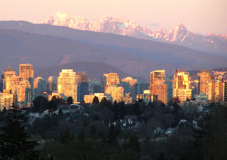 a large city is shown with mountains in the background