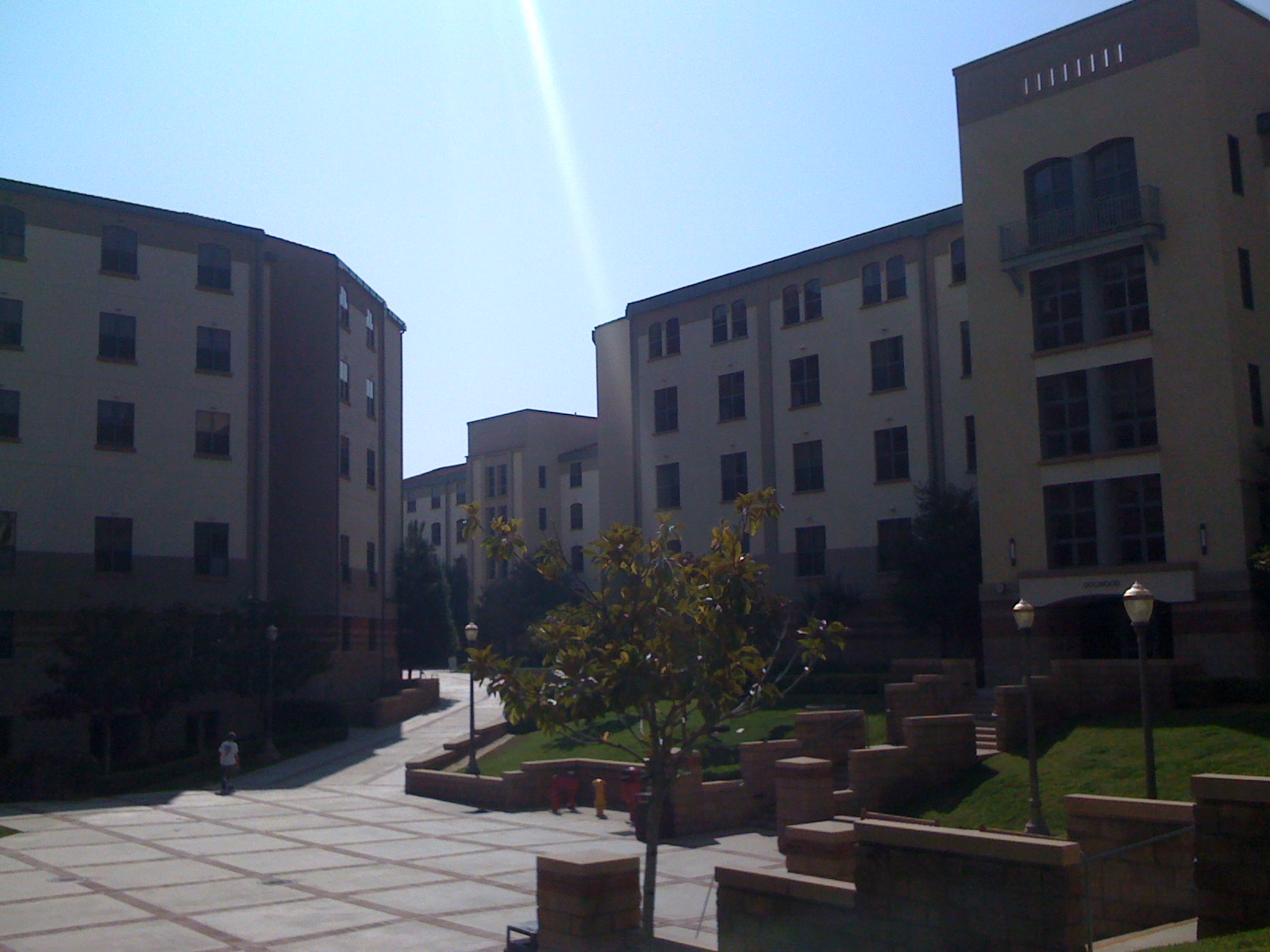 a large group of apartment buildings sitting along side of a park