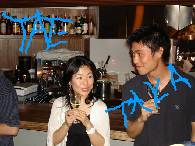 a woman is standing near a man with a wine glass