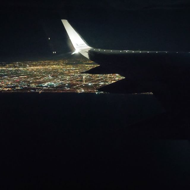 the wing of a plane is seen at night