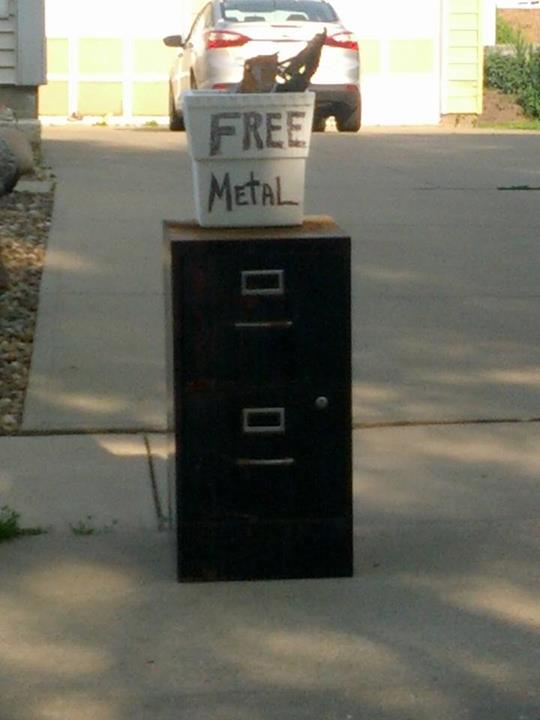 a large metal filing cabinet on a city sidewalk with free metallic