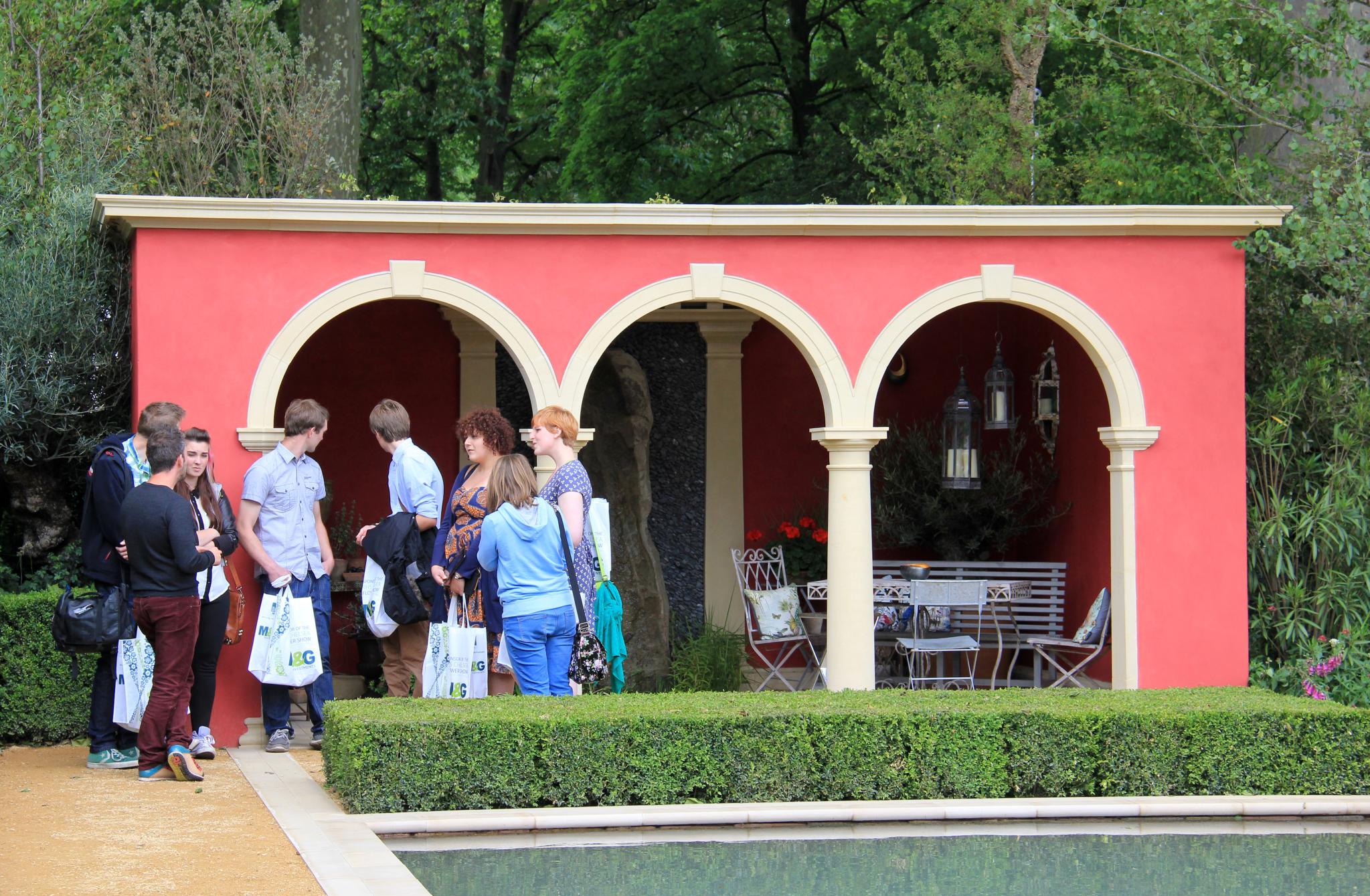 there is a group of people standing in front of a red building