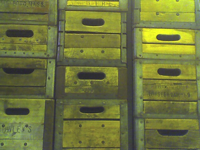 several yellow boxes and one is filled with lots of drawers