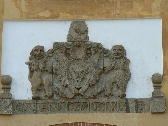 a building wall with the emblem and coat of arms on it