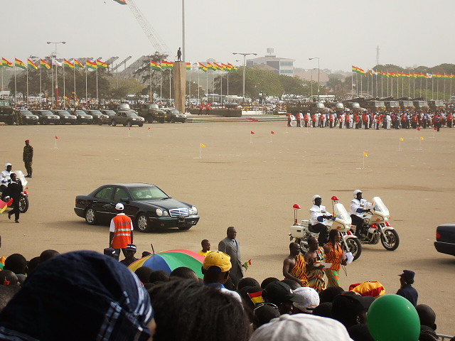 people gathered in the parking lot watching an event