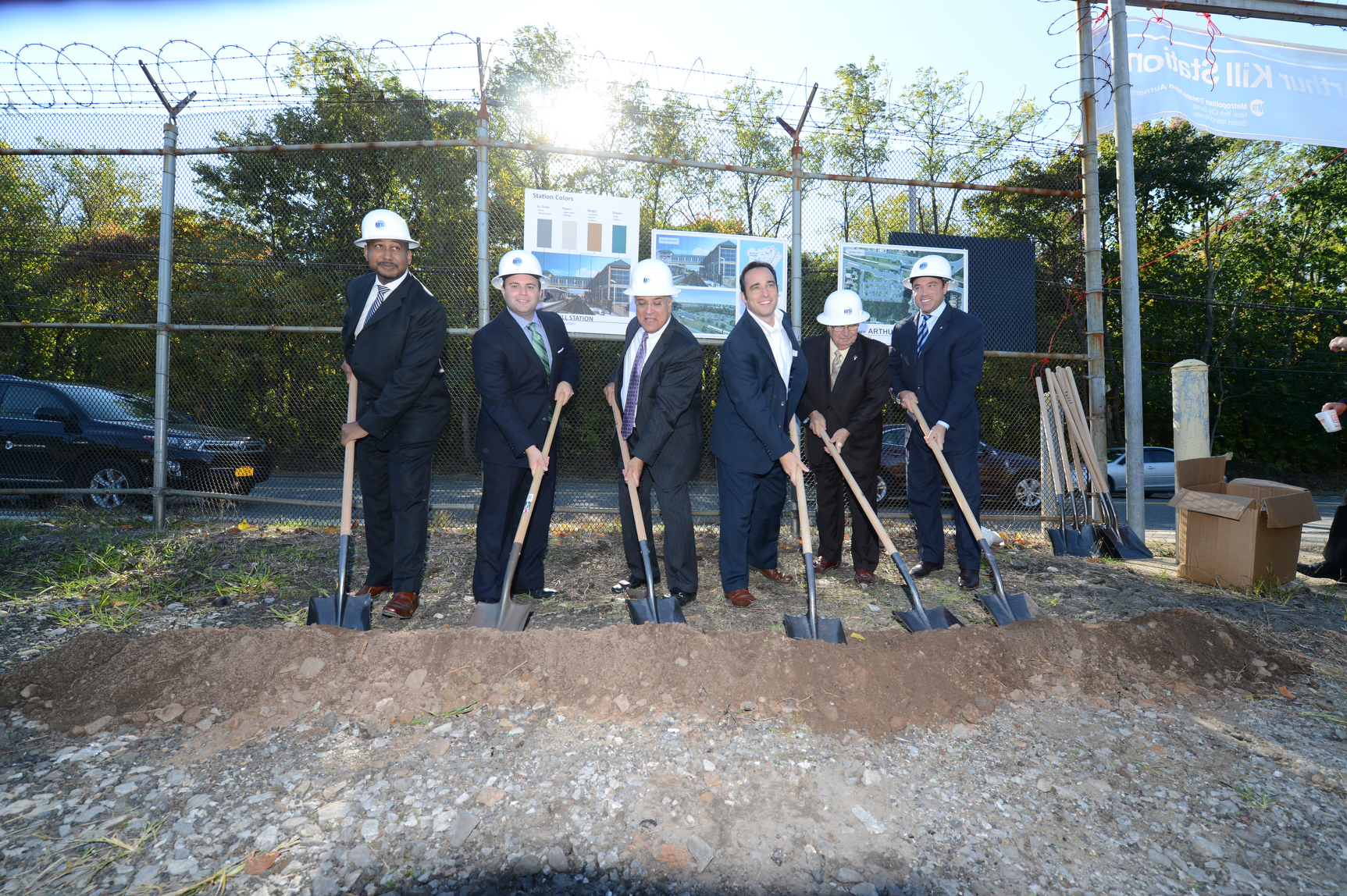 a group of people holding shovels posing for the camera