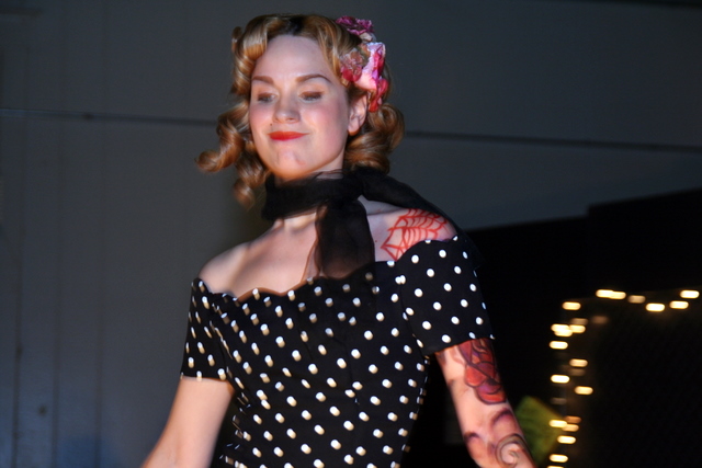 a woman with a short black and white polka dotted dress