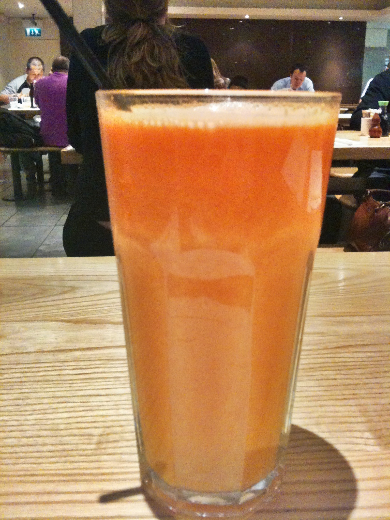 the drink in the tall glass is orange