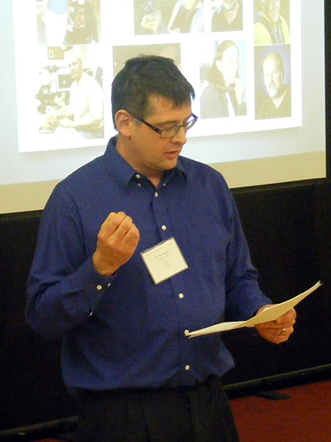 a man at a presentation in front of the crowd