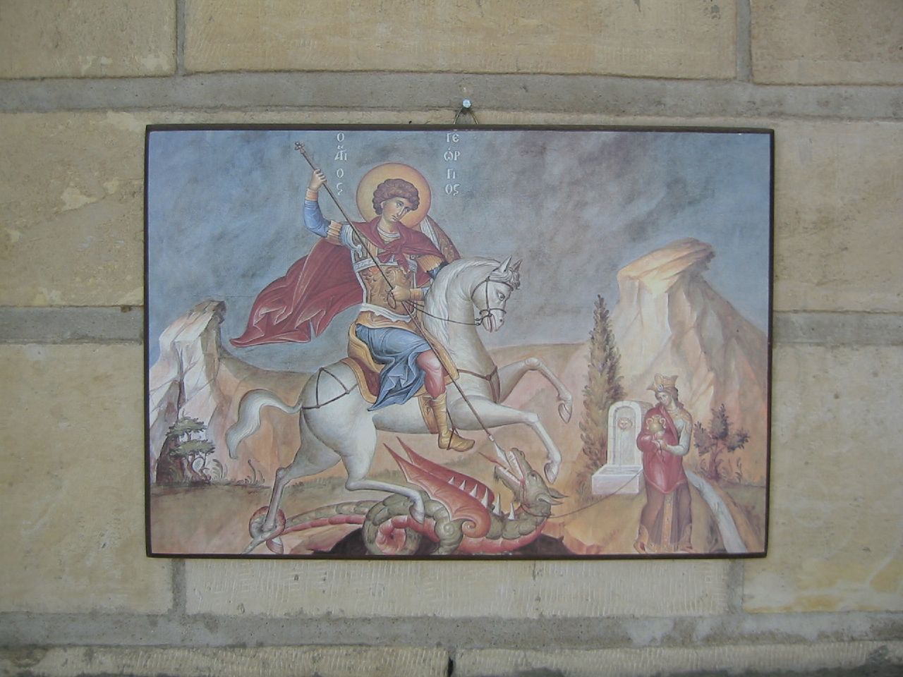 an icon painting hanging on the side of a wall