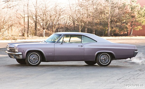 a purple car is sitting in a parking lot