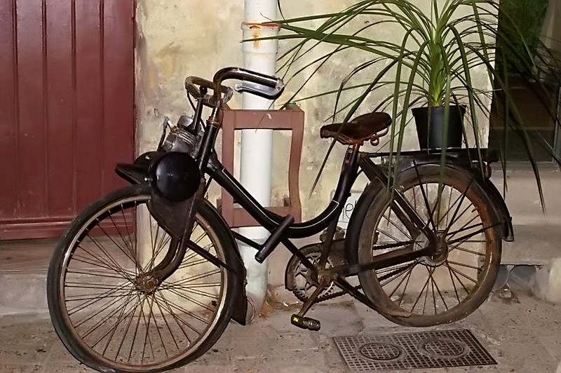 a bicycle parked on the street near a building