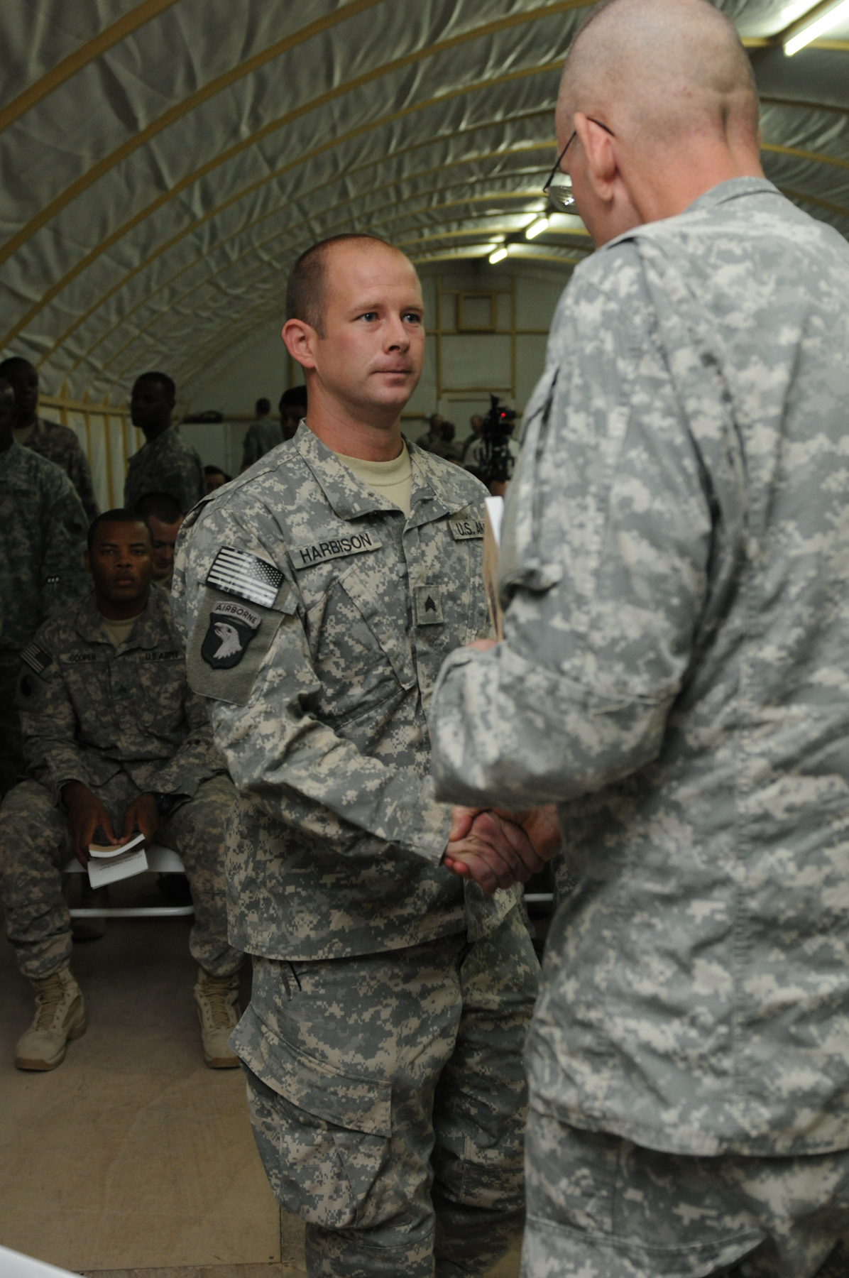 two men in uniform holding hands while talking