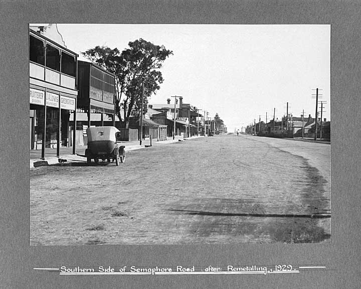 an old po of a town with parked cars