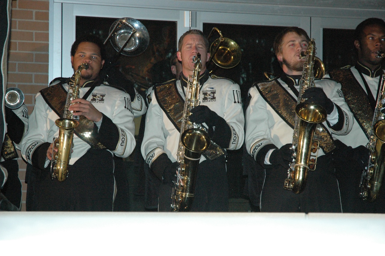 a band of men with their instruments are standing together