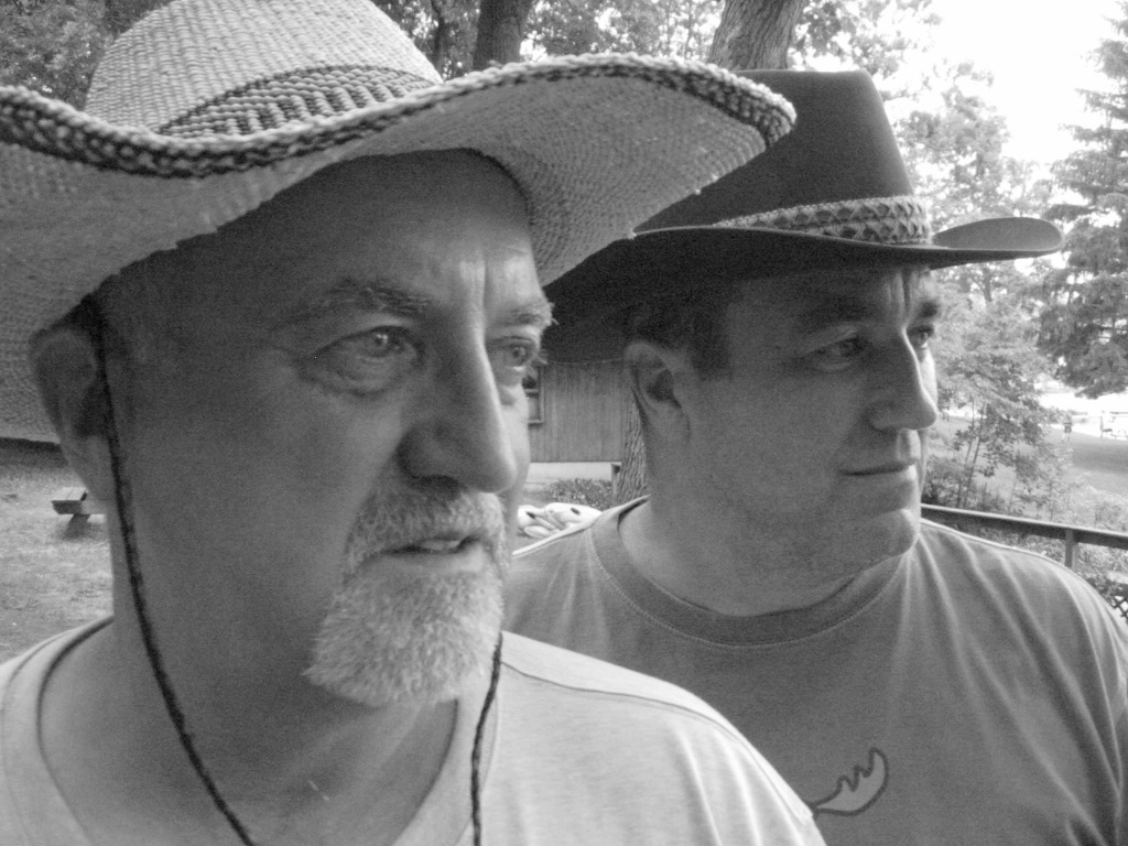 two men wearing hats next to each other