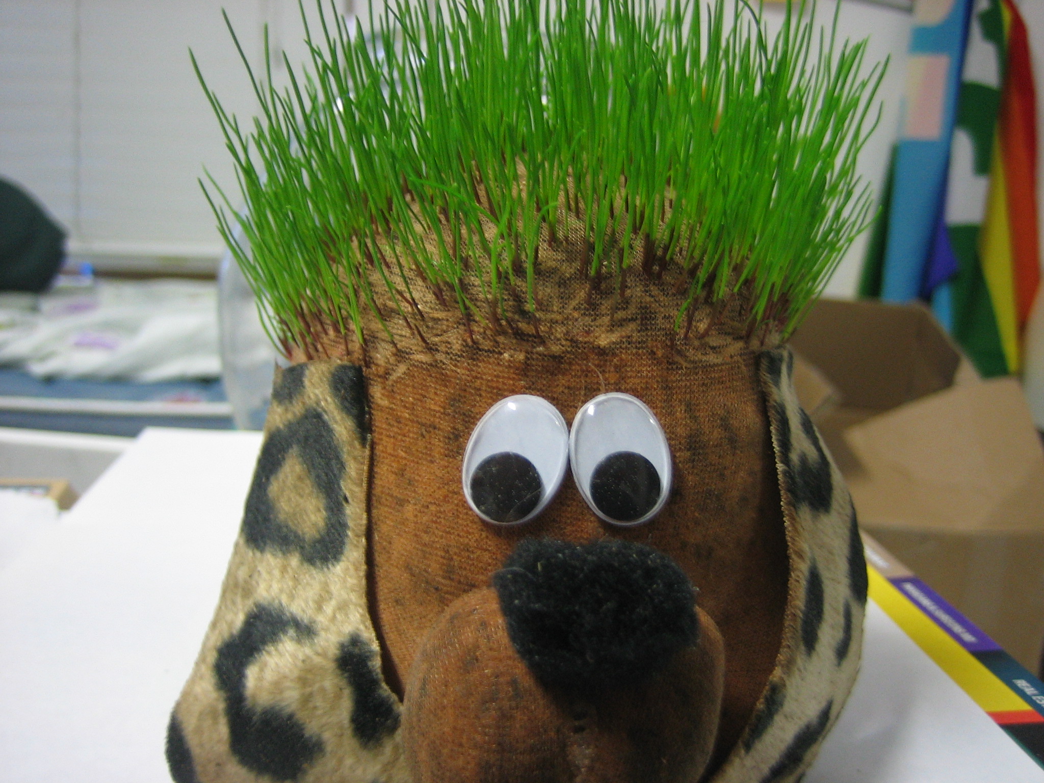 a fake plant with grass on top of it