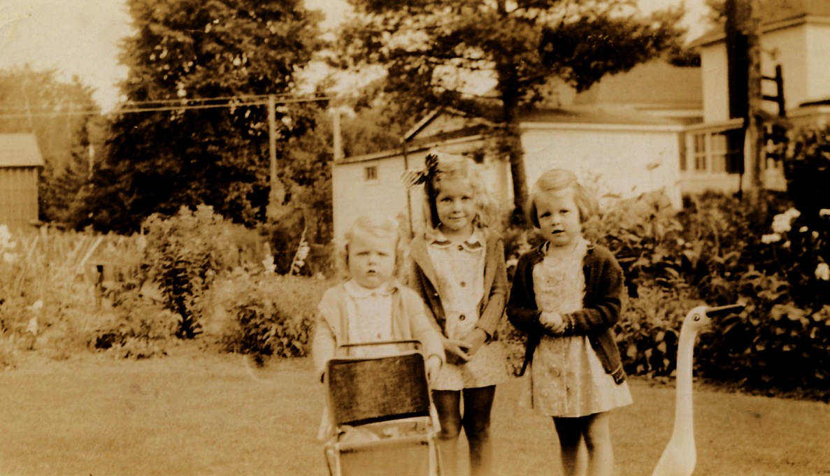 two children are standing next to the small stroller