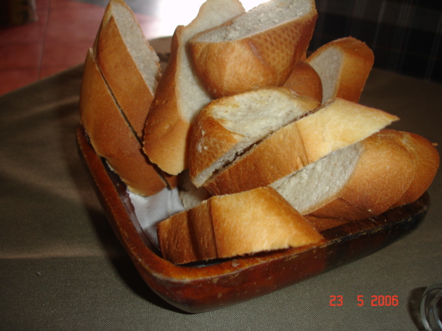 a bunch of bread is in a brown bowl