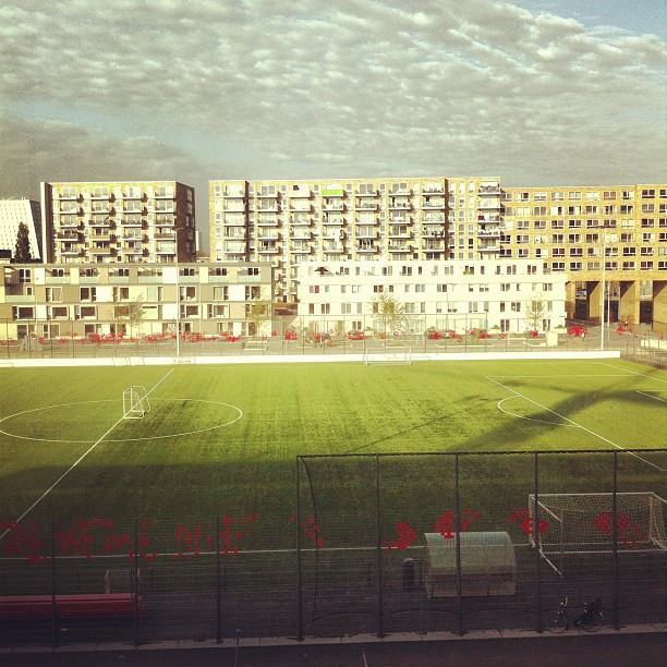 an empty soccer field is shown in the foreground