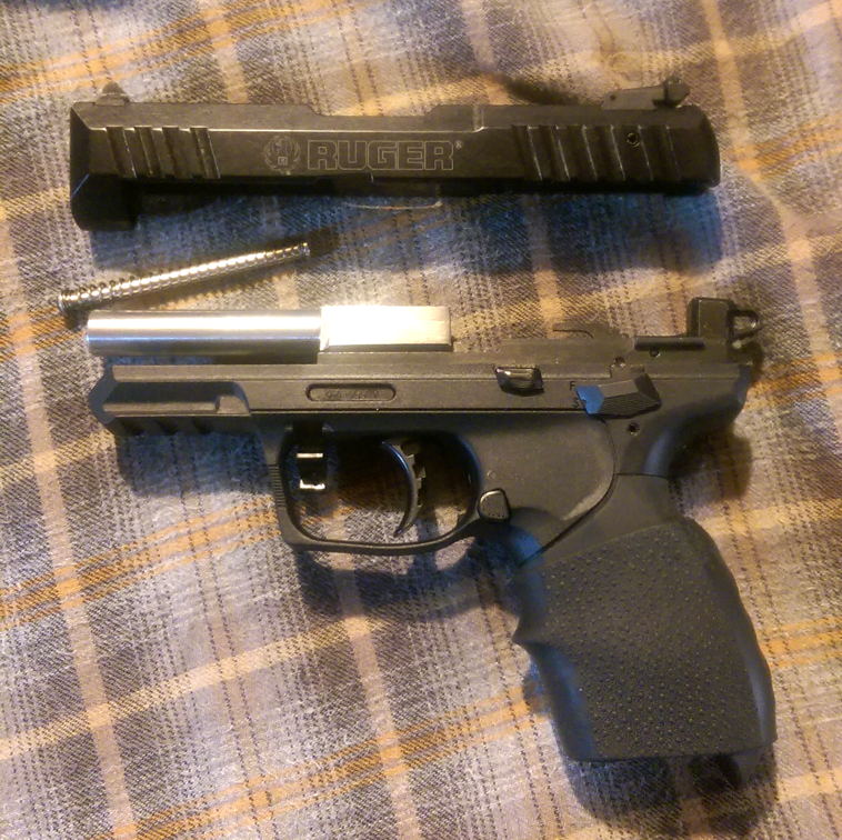 two pistols side by side on top of a blanket