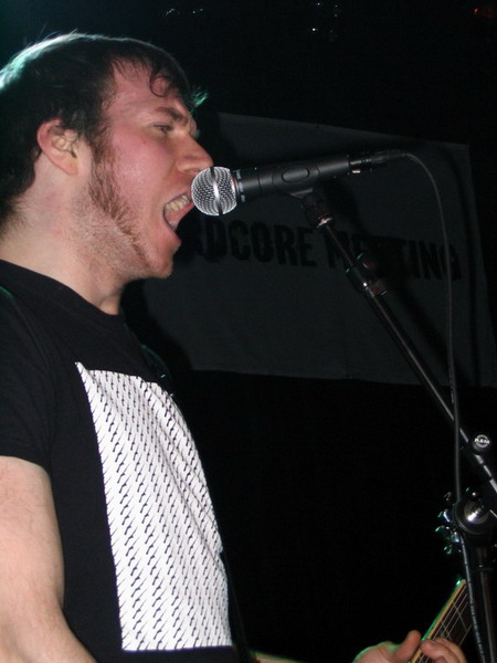 man singing into a microphone with his face close to the microphone