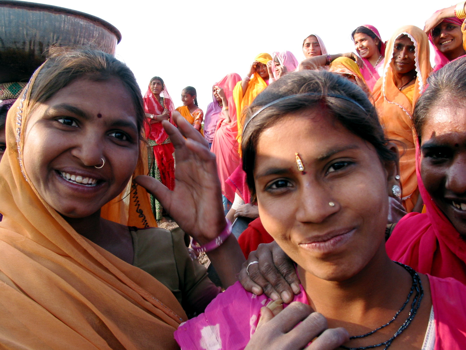 a group of women in pink dresses are posing for the camera