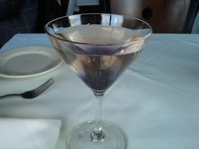 an empty martini glass sitting on a table