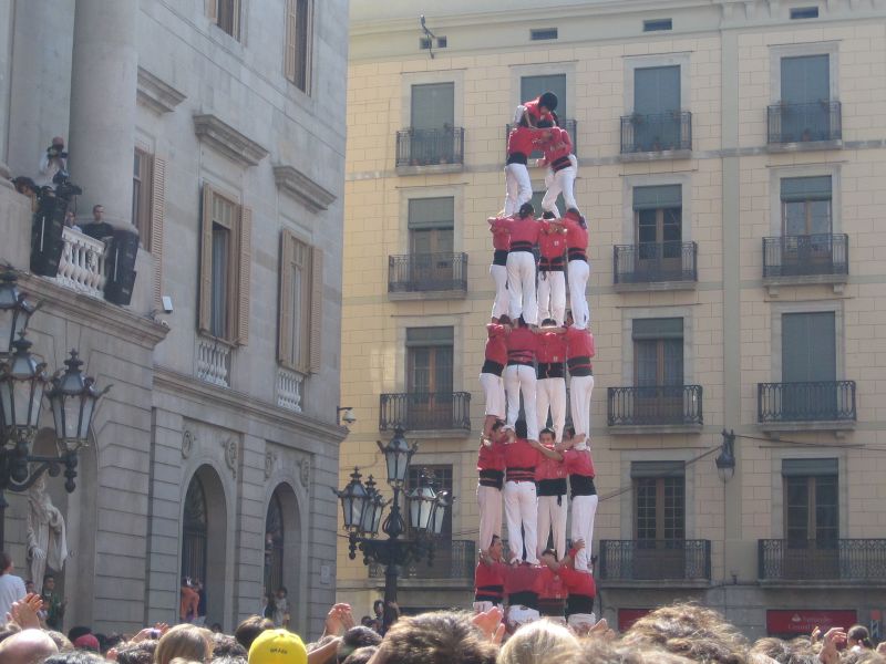 a giant group of people wearing fancy outfits on a tall structure