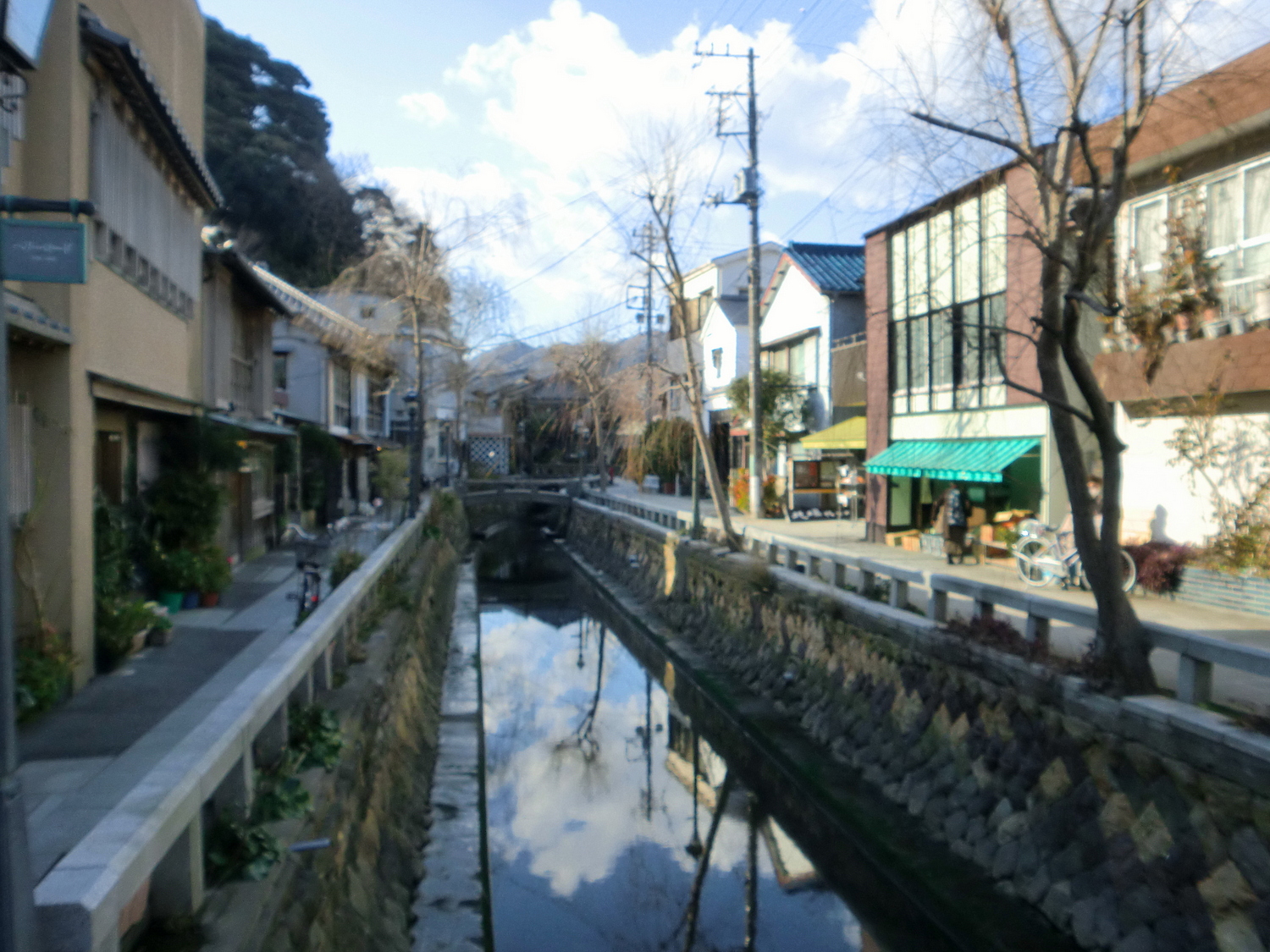 a canal next to a building in a small town