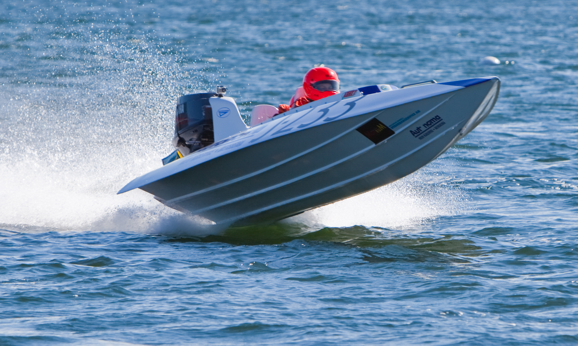 a man is in the water riding a speedboat