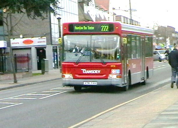 a large red bus driving down a city street