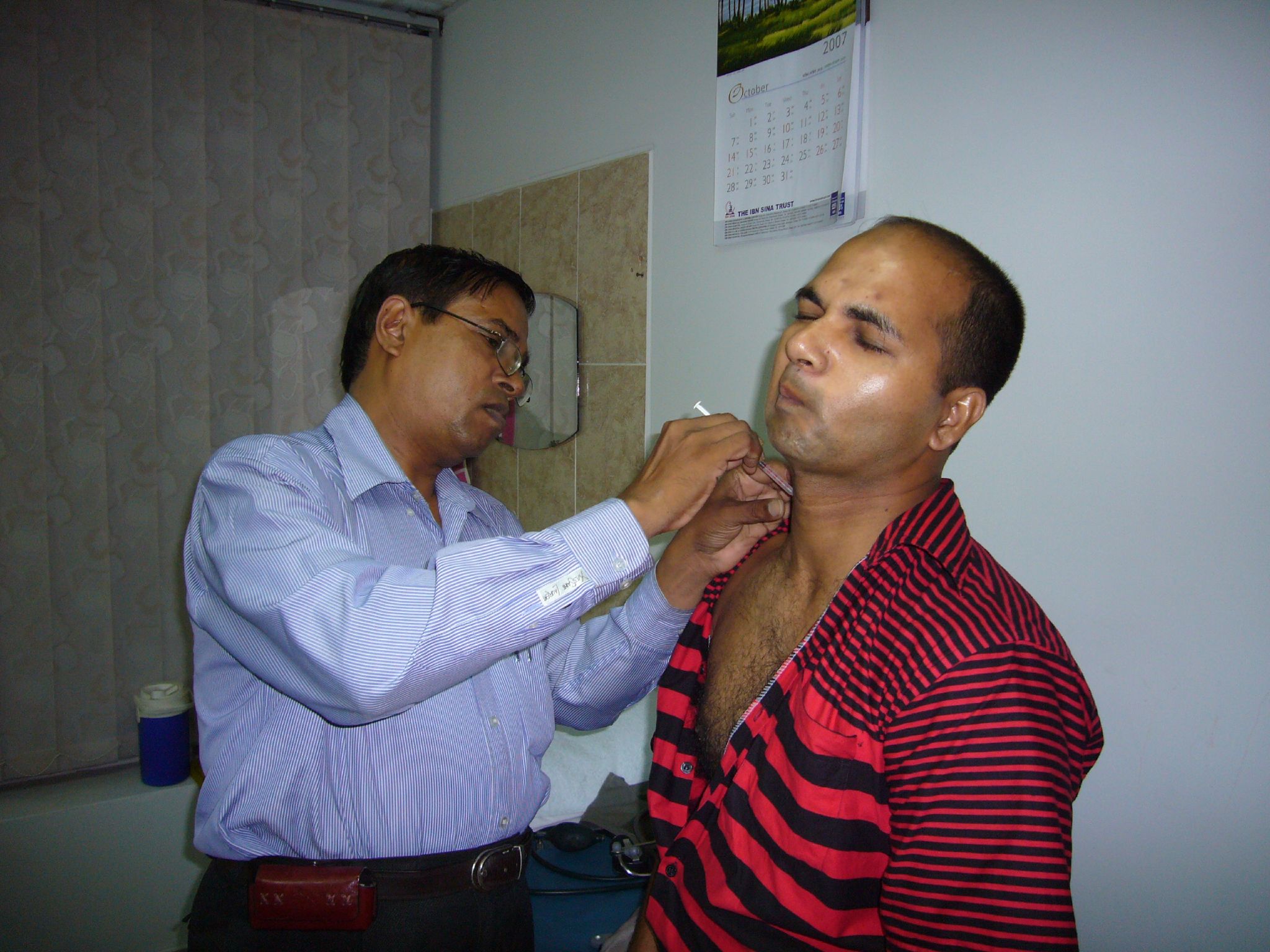 two men standing together while one adjusts another mans collar