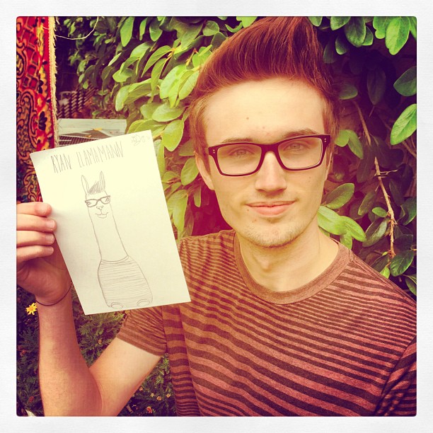 the man is holding up a drawing in his hands