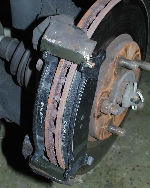a worn chain and disc on a car's wheel
