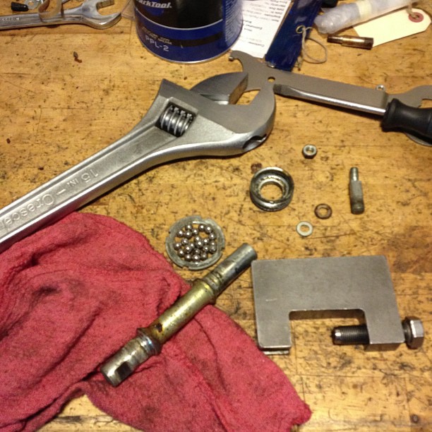 a table with various tools and repair supplies on it