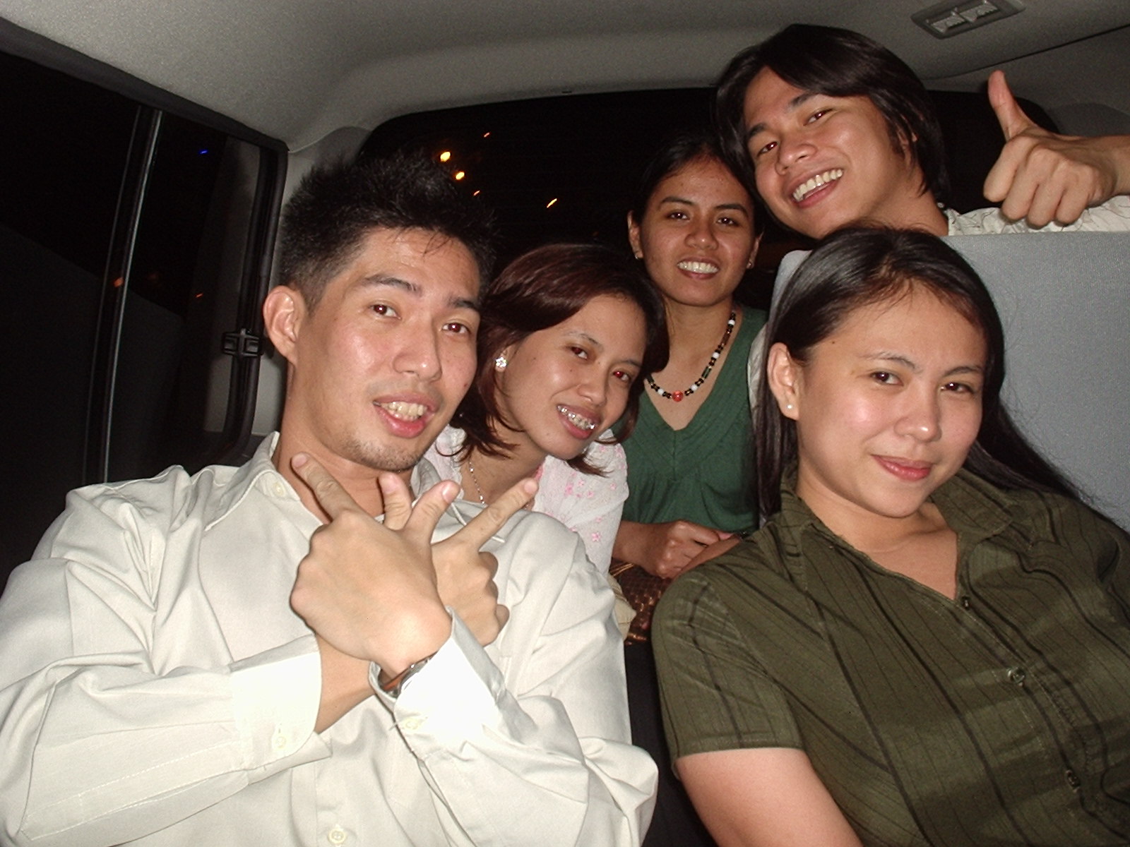 group of people standing in the back of a car