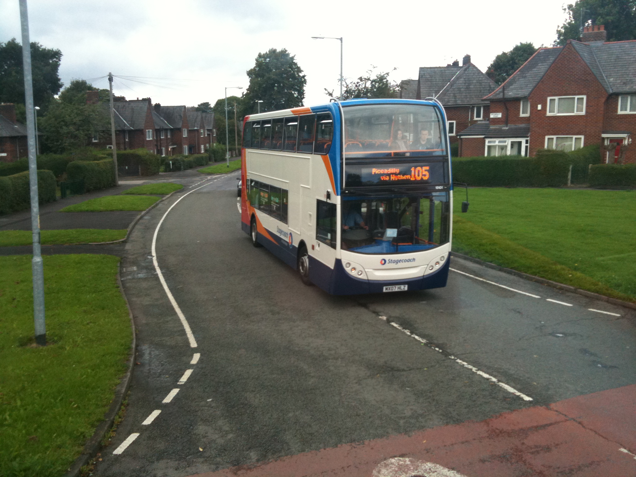 a double - decker bus drives down the street