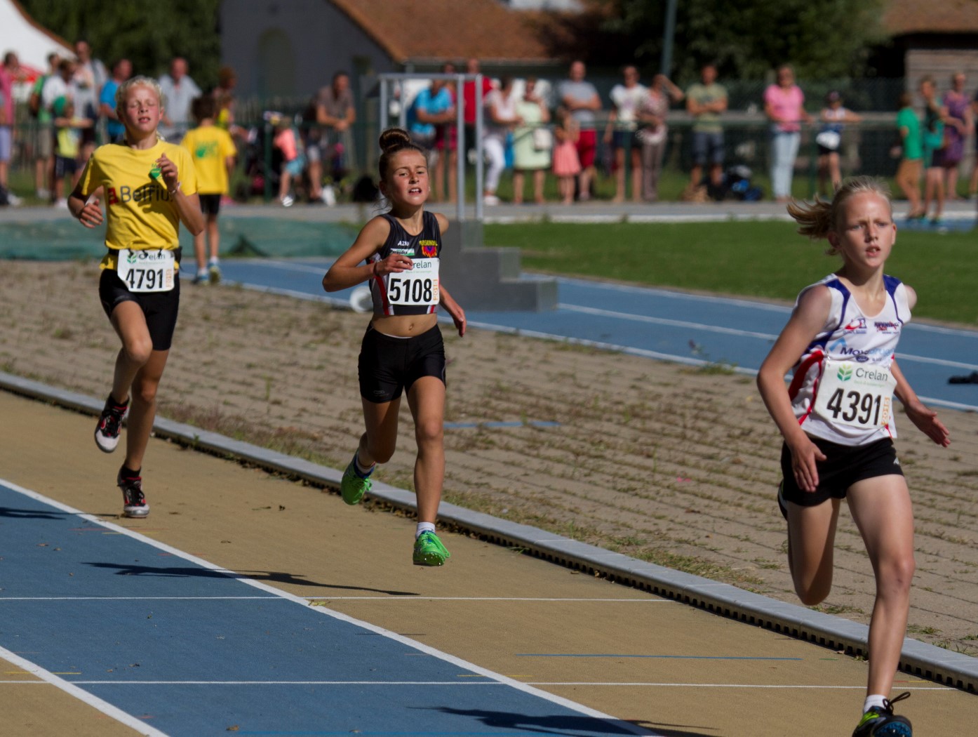 two young women running on a race track