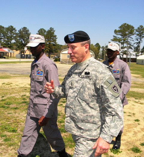 a man in a uniform is standing near other people