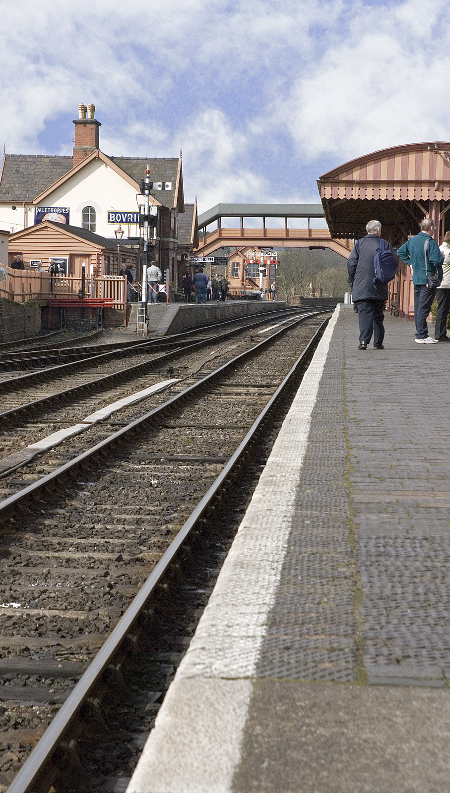 a group of people standing on a train track