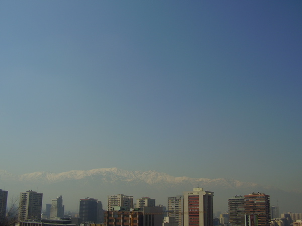 a large city is shown in front of the snow - capped mountain range